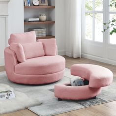 a pink chair and ottoman in a living room