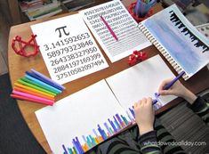 a child is writing on paper with colored pencils next to it and some books