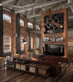 a living room filled with lots of furniture and exposed brick walls in an industrial style