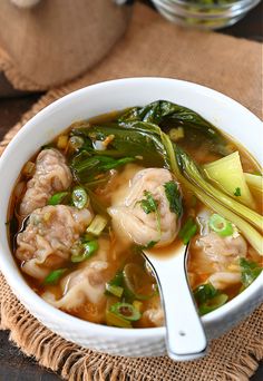 a white bowl filled with meat and vegetable soup