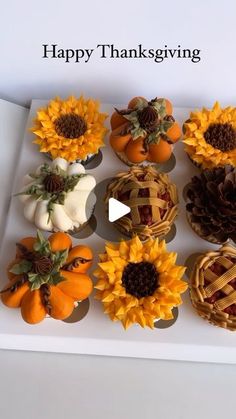 cupcakes decorated with sunflowers and pumpkins in a box