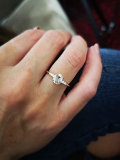 a close up of a person's hand with a ring on it