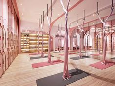 a yoga studio with pink walls and wooden flooring is shown in this artist's rendering