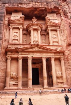 a person standing in front of an ancient building