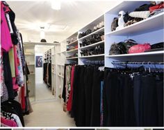 there is a closet full of clothes and shoes in the same room, but with different shelves