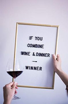 someone holding up a sign that says if you combine wine & dinner, winner