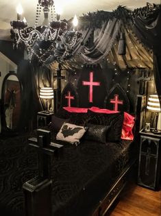 a bed with a cross on the headboard and two lamps hanging from the ceiling