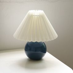 a blue lamp sitting on top of a white table