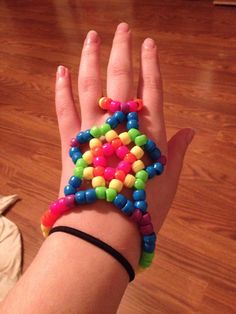 a woman's hand with colorful beads on it