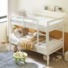 a white bunk bed sitting in a bedroom next to a green table and toy animals