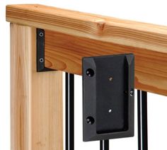 a wooden rail with two black brackets on it