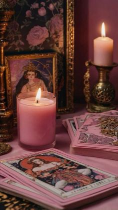 a candle and some cards on a table