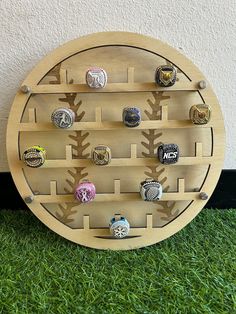 a baseball themed ring display on top of green grass in front of a white wall