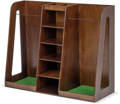 an open wooden bookcase with green carpet on the bottom and side shelves below it