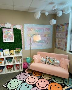 a pink couch sitting on top of a rug next to a book shelf filled with books