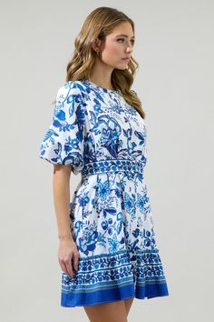 Let your sweet style blossom this season with the help of the Salema Floral Button-Down Mini Dress! The blue florals embellish the short bubble sleeves on this button-down dress. A waist is hugged around by an adjustable belt. Wear your white strappy heels along this mini dress! Blue Mini Dress With Buttons And Short Sleeves, Blue Mini Dress With Floral Embroidery, Blue Button-up Mini Dress For Day Out, Spring Blue Button-up Mini Dress, Light Blue Button-up Dress With Button Closure, White Strappy Heels, Blue Florals, White Floral Dress, Button Down Dress