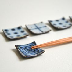 chopsticks are placed next to small blue and white dishes with designs on them