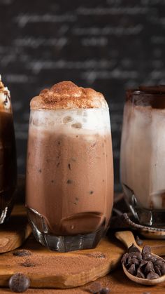 three different kinds of drinks sitting on top of a wooden table next to each other