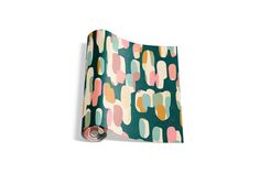 a roll of wrapping paper with an abstract design on it, printed in green and pink