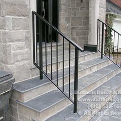 an iron railing on the front steps of a house