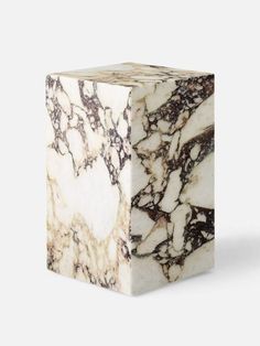 a white and brown marble block on a white background