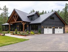 a large house with two garages in front of it and landscaping around the driveway