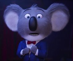 a cartoon koala wearing a blue suit and bow tie with his eyes wide open