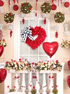 valentine's day decorations with red and white flowers, heart - shaped balloons and wreaths