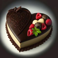 a heart shaped cake with chocolates and strawberries on it's side, in the shape of a heart