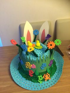 a cake decorated with paper flowers on a table