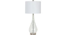 a glass table lamp with a white shade on the base and a silver metal base