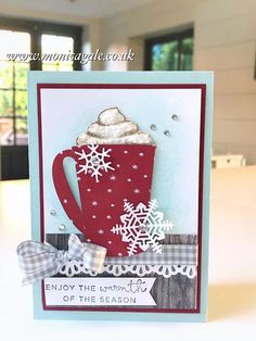 a handmade christmas card with a red mug