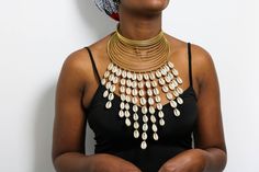 African Brass necklace with cowries, Brass Choker Necklace, Statement Necklace, Cowrie Shell Jewelry, One size fit all, Christmas Gift  The necklace is handmade using brass metal and decorative cowrie shells. The necklace is adjustable hence can fit any neck size. Shipping fee is for the first item only, additional items ship for FREE. DHL Express shipping with 3-5 days delivery. To view our brass collection, click here: https://www.etsy.com/shop/NkoroiCrafts?ref=simple-shop-header-name&listing_id=1295061994&section_id=39639351 *Care instructions* Brass tarnishes with exposure to moisture and oxidation. To clean it, kindly use a lemon wedge. Squeeze the juice and polish along the surface with a clean cloth. Sun Medallion, Cowrie Shell Jewelry, Sunburst Necklace, Sun Necklace, All Christmas, Chocker Necklace, Lemon Wedge, Brass Necklace, African Jewelry