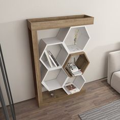 a living room with a couch, table and book shelf on the floor in front of it