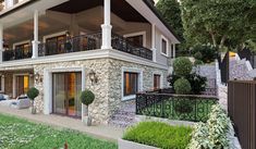 a stone house with balconies on the second floor