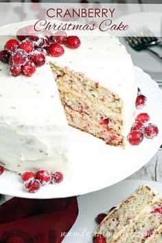 a cake with white frosting and cranberries on top is cut into slices