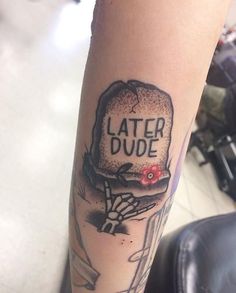 a person with a tattoo on their arm that says later dude