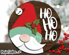 a wooden sign with the words ho hoo on it and a santa claus face