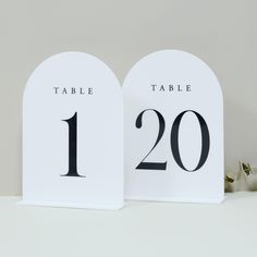 two white table numbers sitting next to each other