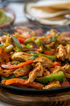 chicken fajita with peppers and bell peppers on a grilling pan, ready to be served