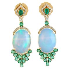 Cast in 14 karat gold. These earrings are handset in 12.48 carats Ethiopian opal, emerald and .34 carats of sparkling diamonds. FOLLOW MEGHNA JEWELS storefront to view the latest collection & exclusive pieces. Meghna Jewels is proudly rated as a Top Seller on 1stDibs with 5 star customer reviews. All items manufactured by us are handmade and can be customized or redesigned. Composition Size: 40X13MM Gold Weight(Gms)-6.347 Diamond Wt(Cts)-.34 Opal, Emerald Wt(Cts)-12.48 Fine Jewels, Gorgeous Jewelry, Top Seller, Emerald Diamond, Opal Jewelry, Sparkle Diamonds, Ethiopian Opal, Gemstone Earrings, Beautiful Jewelry