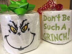 two toilet paper wrapped in plastic with grin face on them and the words, don't be such a grin