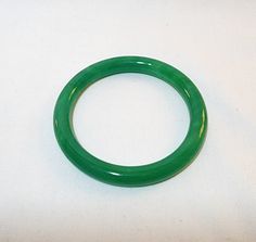 "Vintage bright green jade circle/bangle bracelet. 3\" in diameter. Inside diameter is 2.25\". This goes over my hand and fits me. I have a 6\" wrist." Adjustable Green Jade Bangle, Adjustable Green Bangle, Adjustable Green Round Bangle, Bleached Shirt, Jade Bangle, Jade Bracelet, Green Jade, Jade Green, Bright Green