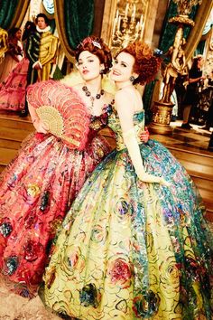 two women in colorful dresses standing next to each other