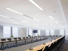 an empty conference room with long tables and chairs