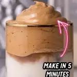 a jar filled with chocolate pudding sitting on top of a table