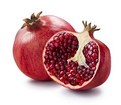 two pomegranates cut in half on a white background