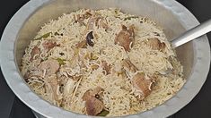 a bowl filled with rice and meat on top of a stove