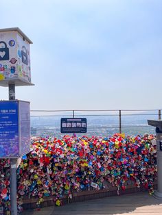 a fence covered in lots of locks and padlocks