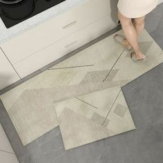 a woman is standing on the kitchen floor with her feet in the oven door handle